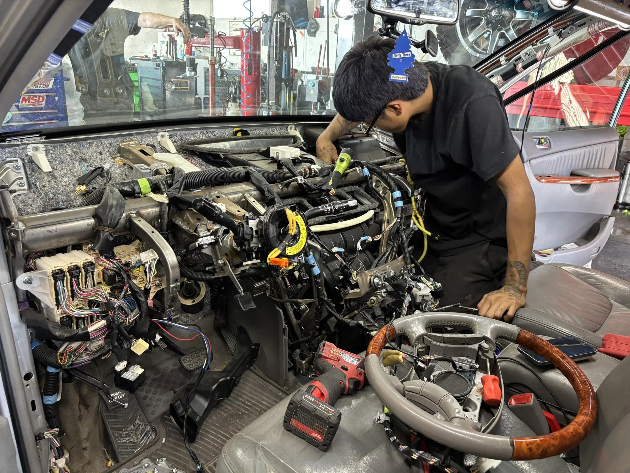 Mechanic working in an engine bay at Cascade Auto and Marine