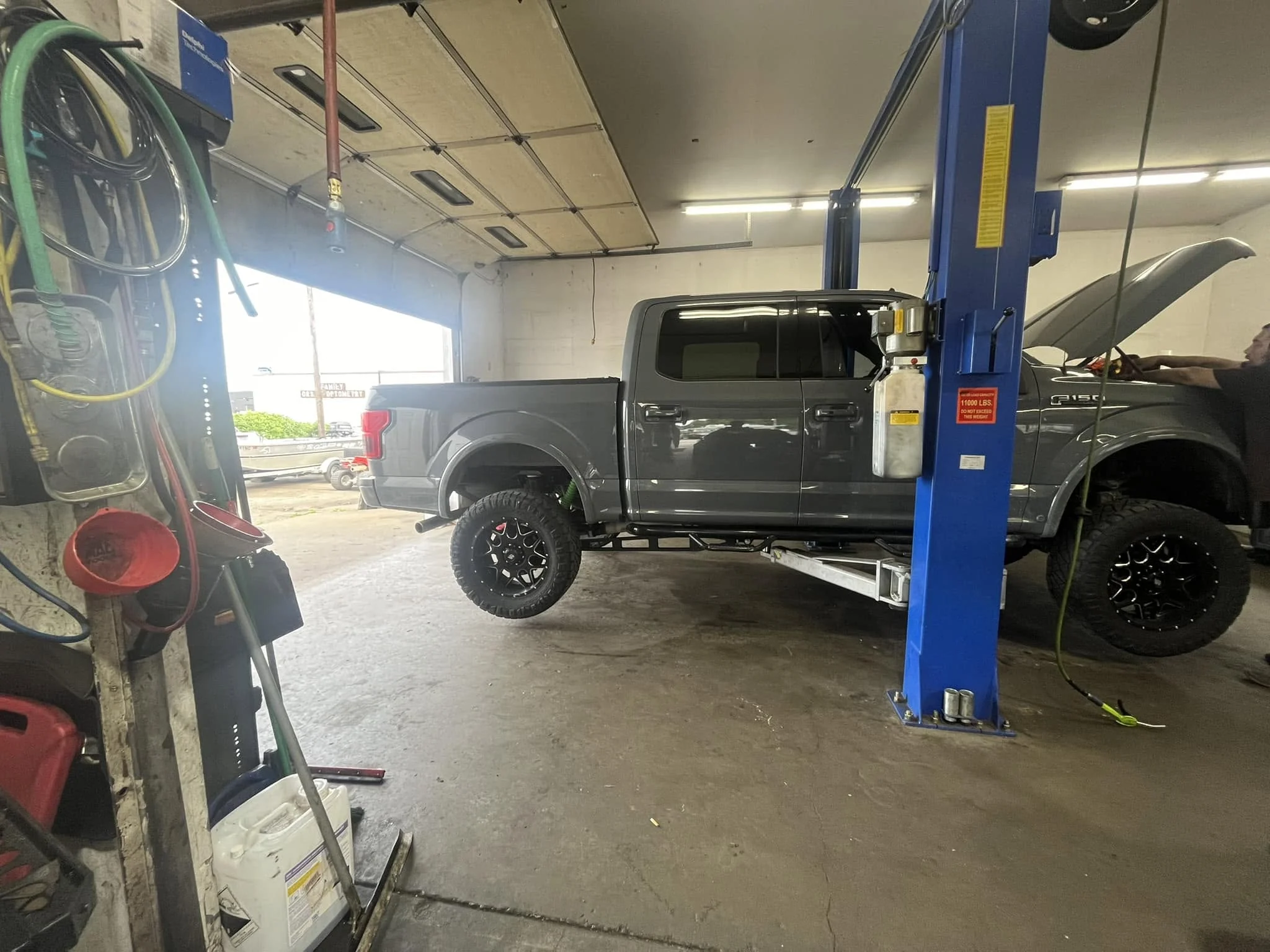 Lifted Jeep in a Cascade service bay